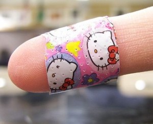 finger wrapped in colorful child's bandaid